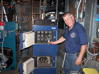 Town of Gorham Fire Chief Rick Eichler explains the heat exchange rods on the new TARM boiler.